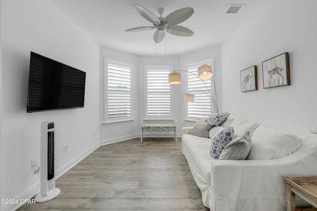 living room featuring light wood-type flooring and ceiling fan