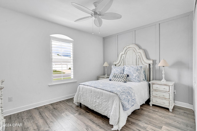 bedroom with ceiling fan and hardwood / wood-style flooring