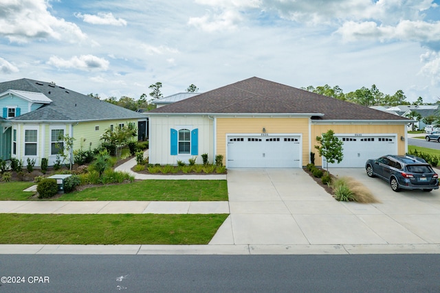 view of front of property with a front yard and a garage