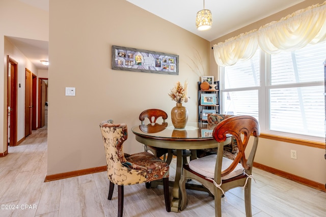 dining area featuring light wood-type flooring and baseboards