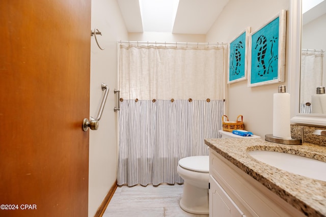 bathroom with curtained shower, vanity, and toilet