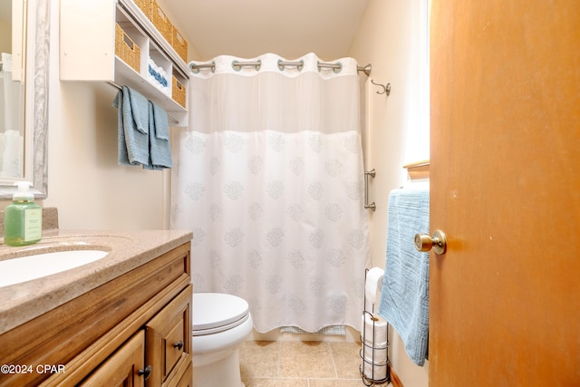 bathroom with curtained shower, vanity, toilet, and tile patterned floors