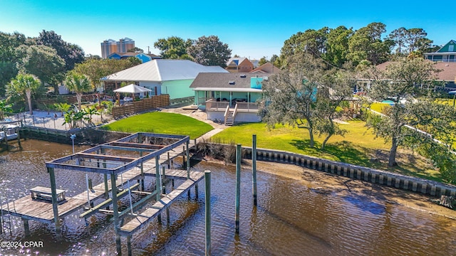 dock area with a lawn and a water view