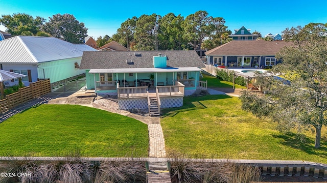 view of front facade featuring fence private yard, a deck, and a front lawn