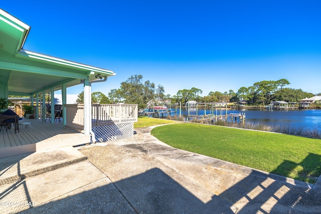 view of yard featuring a dock and a deck with water view