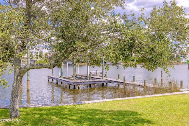 dock area with a water view and a yard