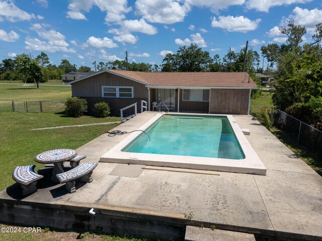 view of pool with a fire pit, a yard, and a patio