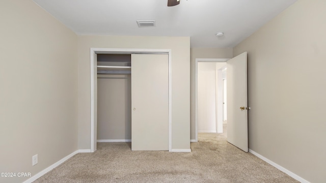 unfurnished bedroom with a ceiling fan, visible vents, baseboards, a closet, and carpet