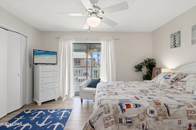 bedroom with light hardwood / wood-style floors, a closet, access to exterior, ceiling fan, and a textured ceiling