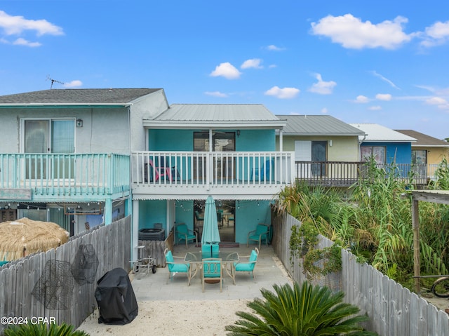 back of property featuring a patio and a balcony