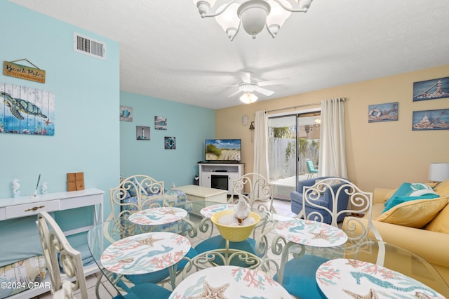 dining area with a textured ceiling and ceiling fan