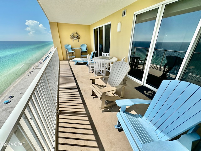 balcony with a beach view and a water view