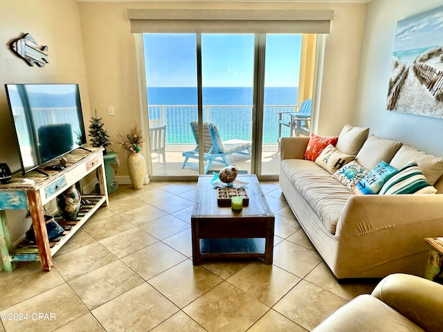 living room with a water view and light tile patterned floors