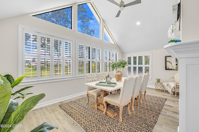 dining space featuring ceiling fan, vaulted ceiling, and light hardwood / wood-style floors