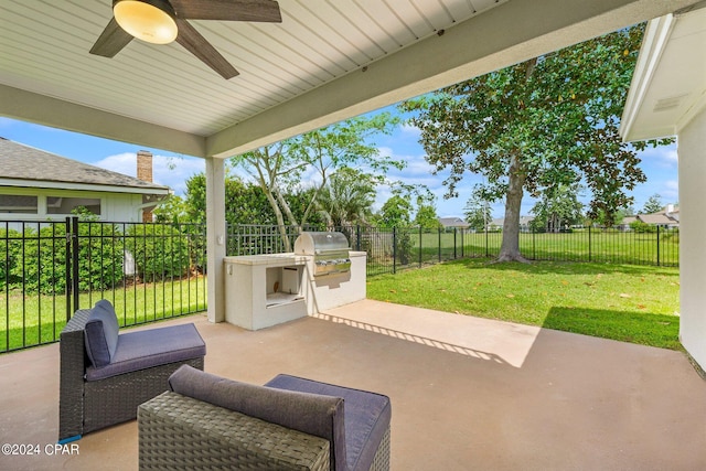 view of patio featuring ceiling fan, grilling area, and exterior kitchen