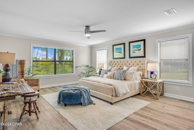 bedroom featuring light hardwood / wood-style flooring, multiple windows, and ceiling fan