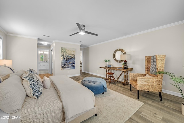 bedroom featuring ceiling fan, ornamental molding, light hardwood / wood-style flooring, and ensuite bathroom