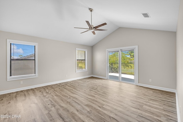 empty room featuring ceiling fan, light hardwood / wood-style floors, and vaulted ceiling