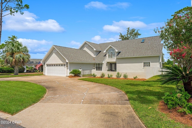 view of front of property with a front lawn and a garage