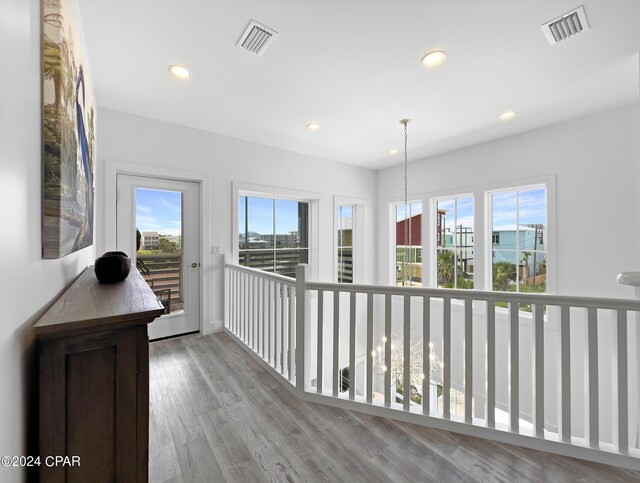 hall with visible vents, wood finished floors, and recessed lighting