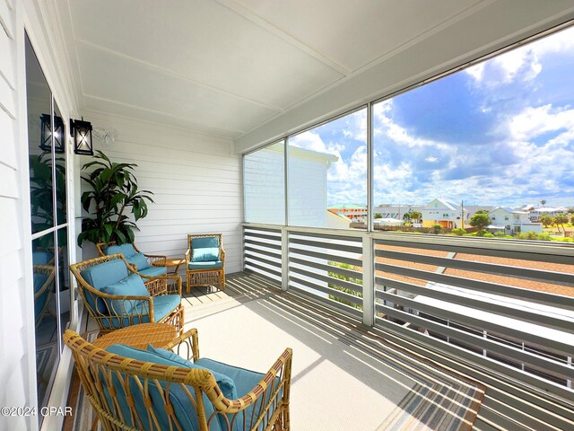 sunroom featuring a residential view