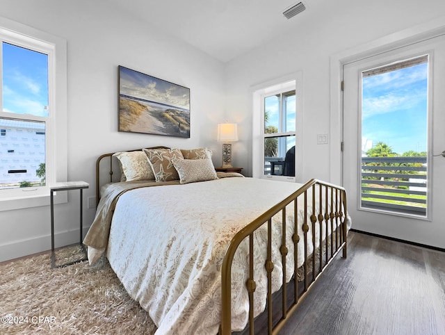 bedroom with dark hardwood / wood-style flooring