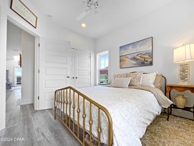 bedroom with a closet, ceiling fan, and wood-type flooring