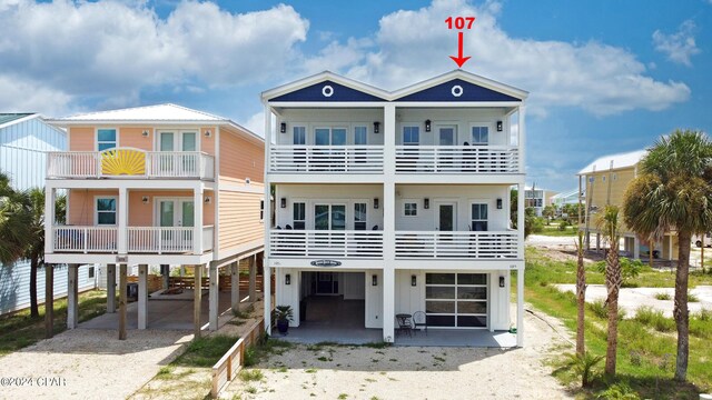 coastal inspired home featuring driveway and a carport
