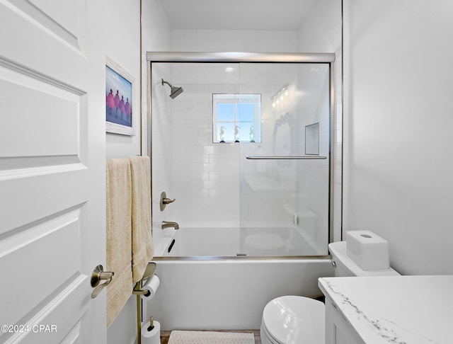 full bathroom with shower / bath combination with glass door, toilet, and vanity