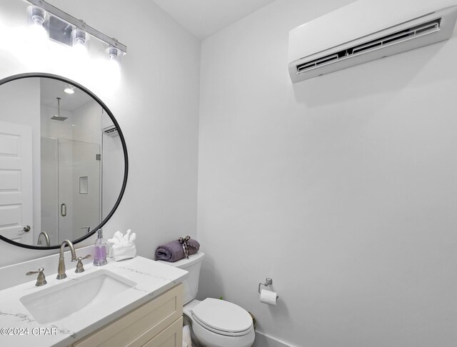 full bathroom with toilet, vanity, a shower with door, and a wall mounted air conditioner