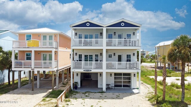 rear view of house with a balcony and a carport