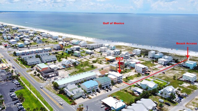 drone / aerial view featuring a water view and a beach view