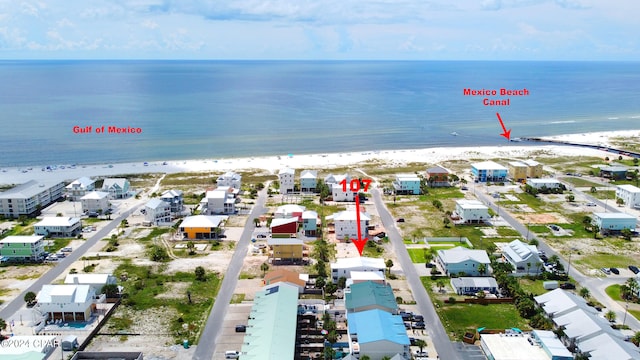 bird's eye view with a water view and a view of the beach