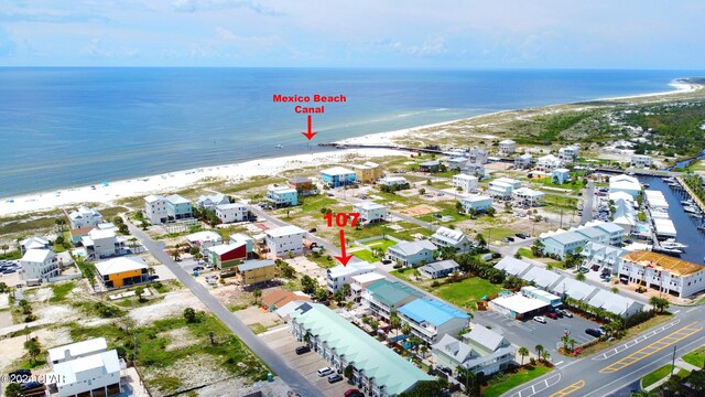 birds eye view of property featuring a view of the beach and a water view