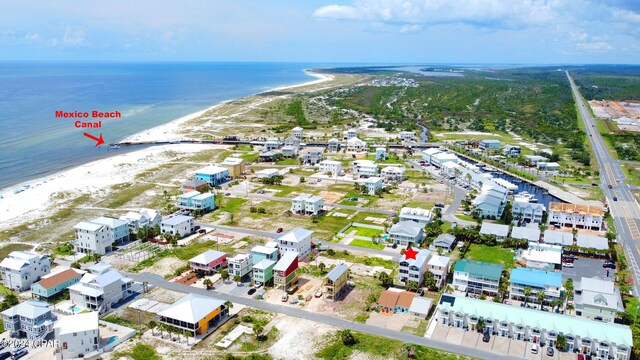 drone / aerial view with a water view and a view of the beach