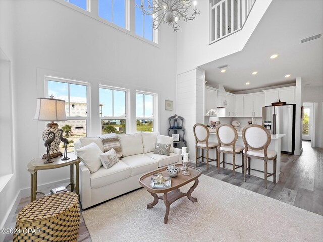 living area with a wealth of natural light, wood finished floors, baseboards, and recessed lighting