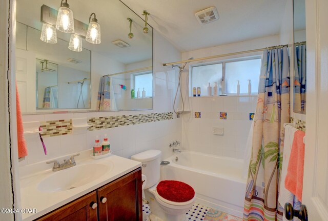 full bathroom with toilet, vanity, shower / bathtub combination with curtain, decorative backsplash, and tile walls