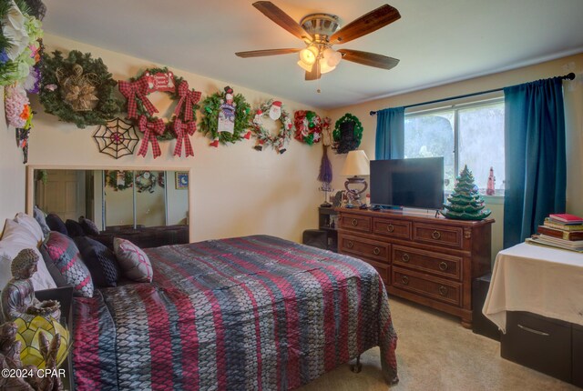 carpeted bedroom with ceiling fan