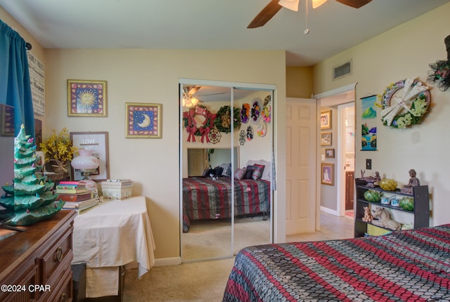 bedroom with a closet, ceiling fan, and light colored carpet