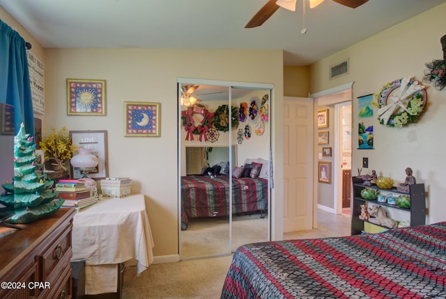 bedroom with a closet, light colored carpet, visible vents, ceiling fan, and baseboards