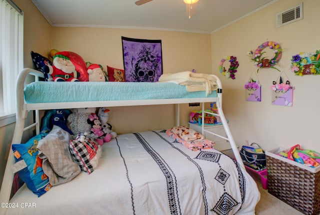 bedroom with ceiling fan, carpet floors, and ornamental molding