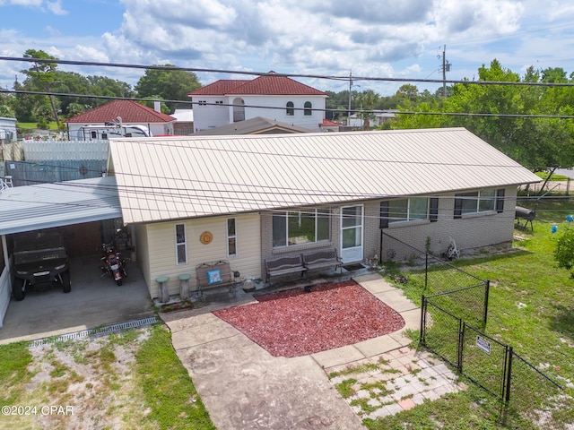 view of front of house with brick siding, a front yard, fence, and a gate