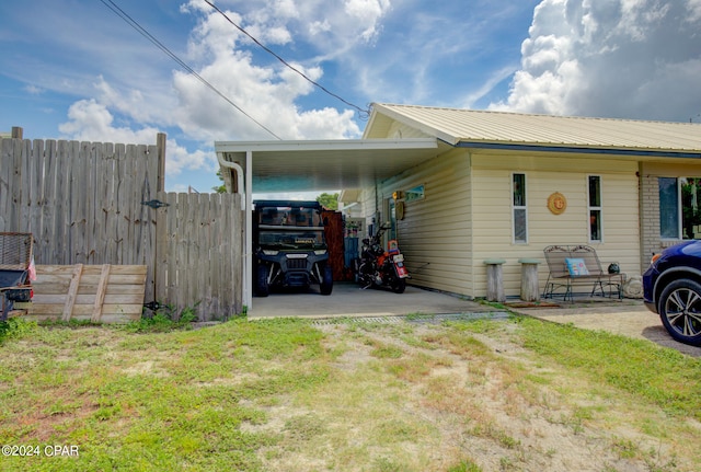 view of side of home with a lawn and a carport