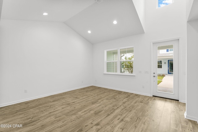 interior space featuring light hardwood / wood-style floors and vaulted ceiling