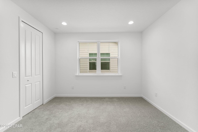 unfurnished bedroom featuring a closet and carpet floors