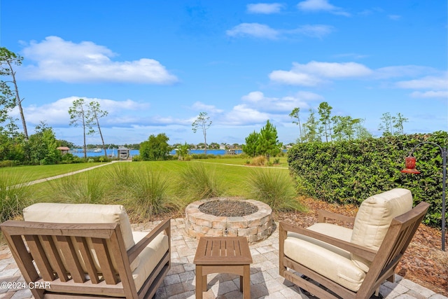 view of patio / terrace with an outdoor fire pit and a water view