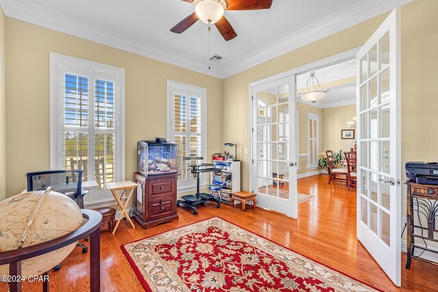 home office with ceiling fan, hardwood / wood-style flooring, crown molding, and french doors