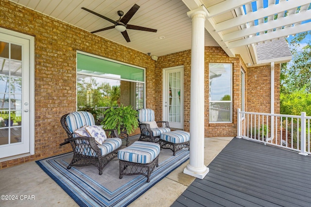 wooden terrace with a porch and ceiling fan