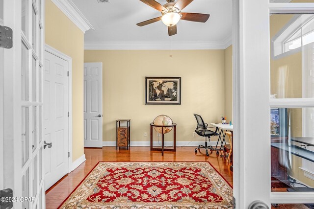 sitting room featuring crown molding, hardwood / wood-style flooring, and ceiling fan