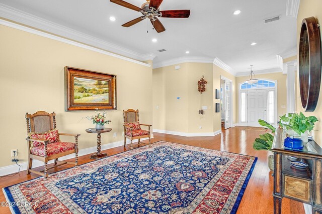 sitting room featuring ornamental molding, hardwood / wood-style floors, and ceiling fan